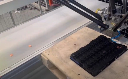 Delta robot with vision system for tracking and positioning metal parts on a tray